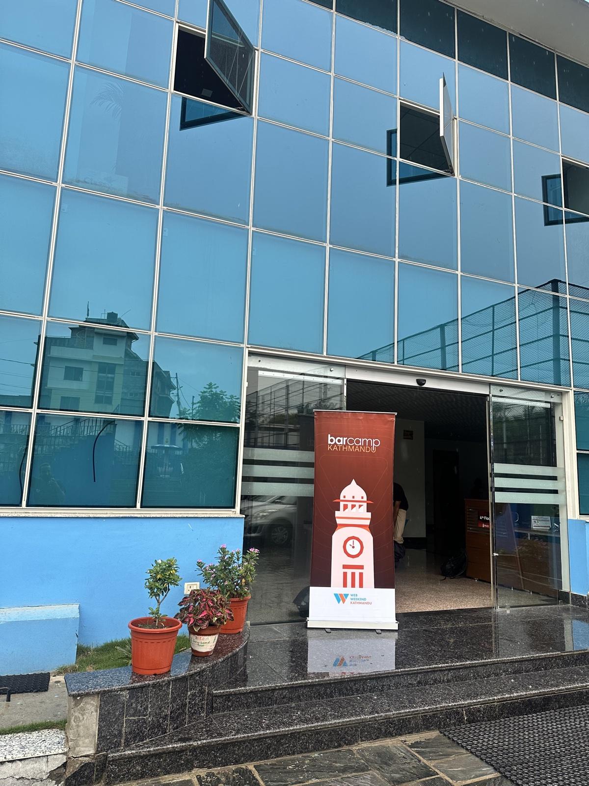 The venue entrance in 2025, with a BarCamp Kathmandu roll-up banner beside the doors.